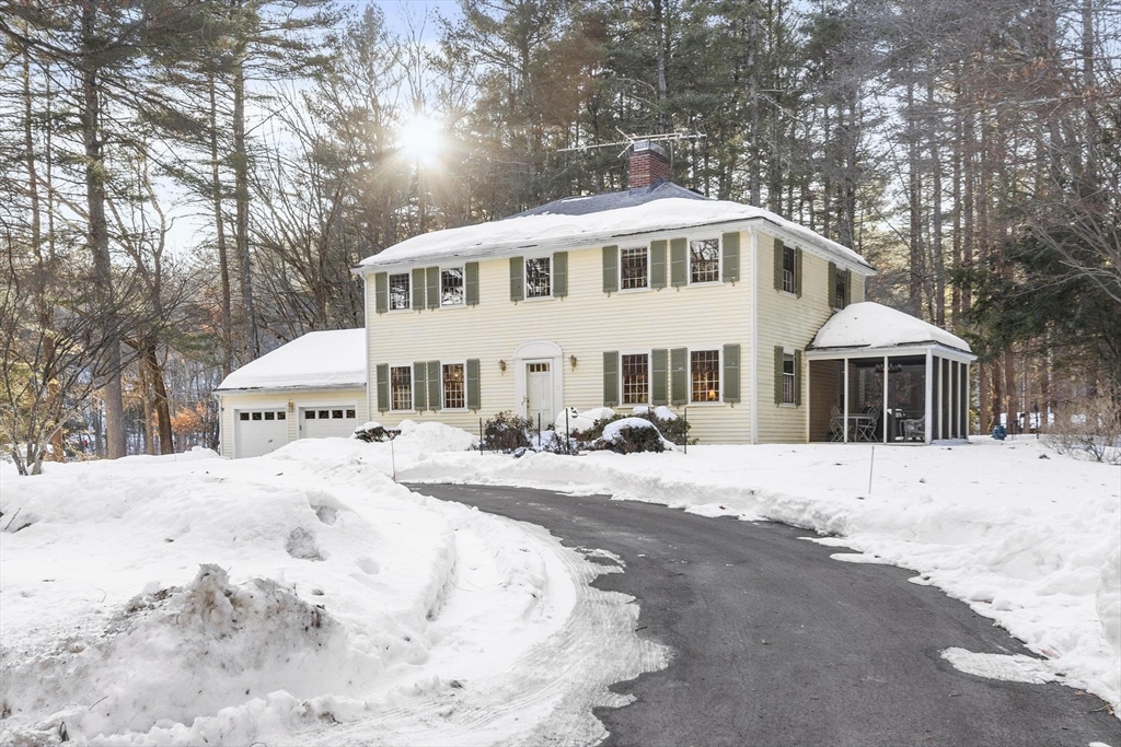 265 College Road Concord, MA 01742 - Photo 42 of 42 a front view of a house with a dirt yard and a large tree