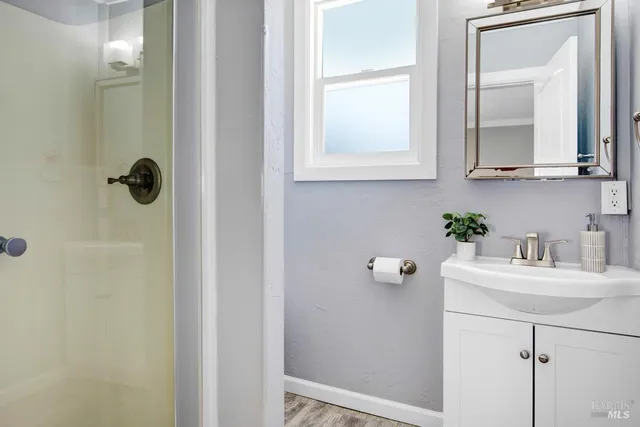 a bathroom with a sink vanity and mirror