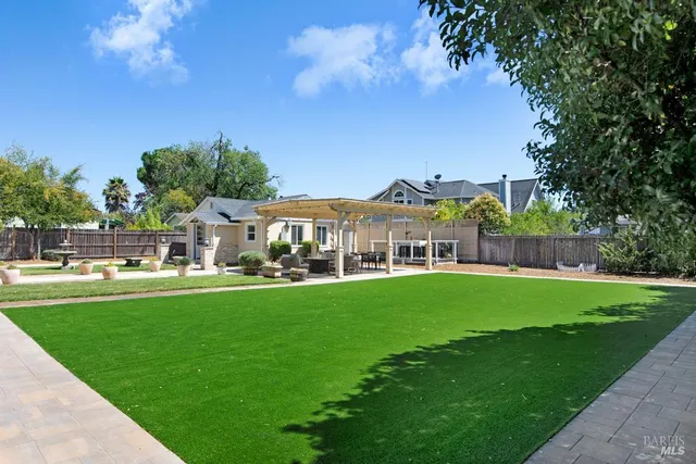 a front view of house with yard and outdoor seating