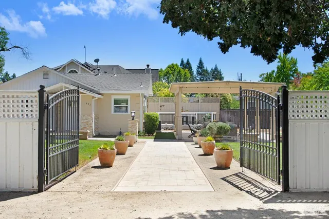 a view of a patio with couches table and chairs and potted plants