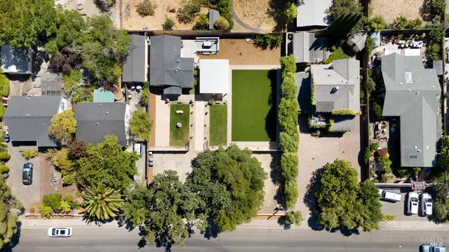 an aerial view of a residential houses with outdoor space