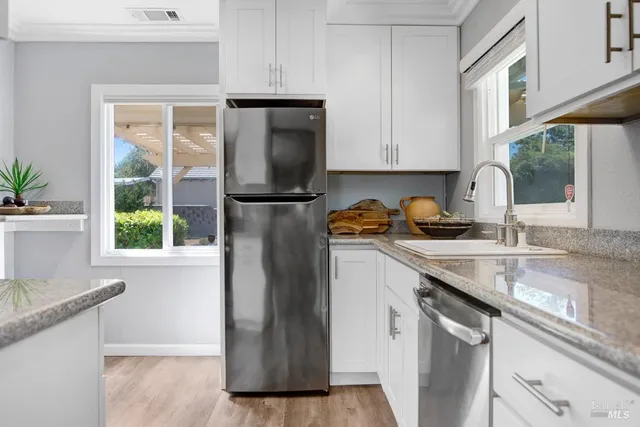 a kitchen with a sink a refrigerator and window
