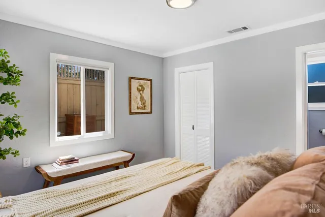 a bedroom with a bed and a window