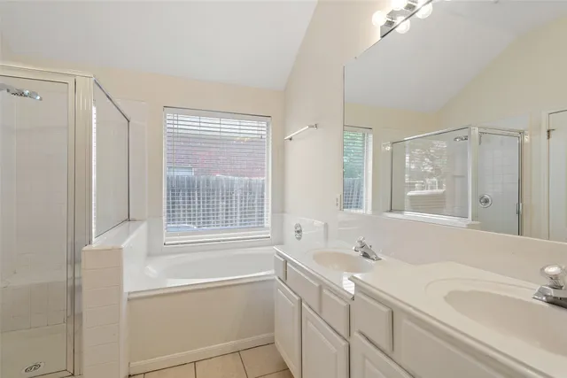 a bathroom with a tub sink and mirror