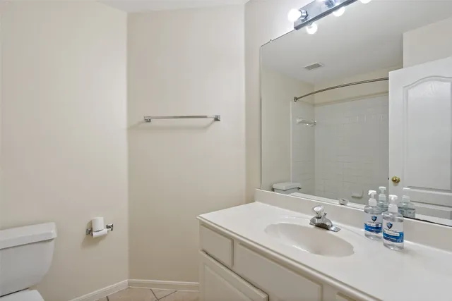 a bathroom with a sink toilet and mirror