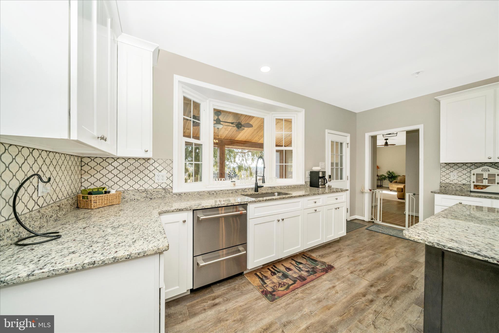 8730 Mapleville Road Mount Airy, MD 21771 - Photo 15 of 65 a large kitchen with granite countertop a sink and a stove