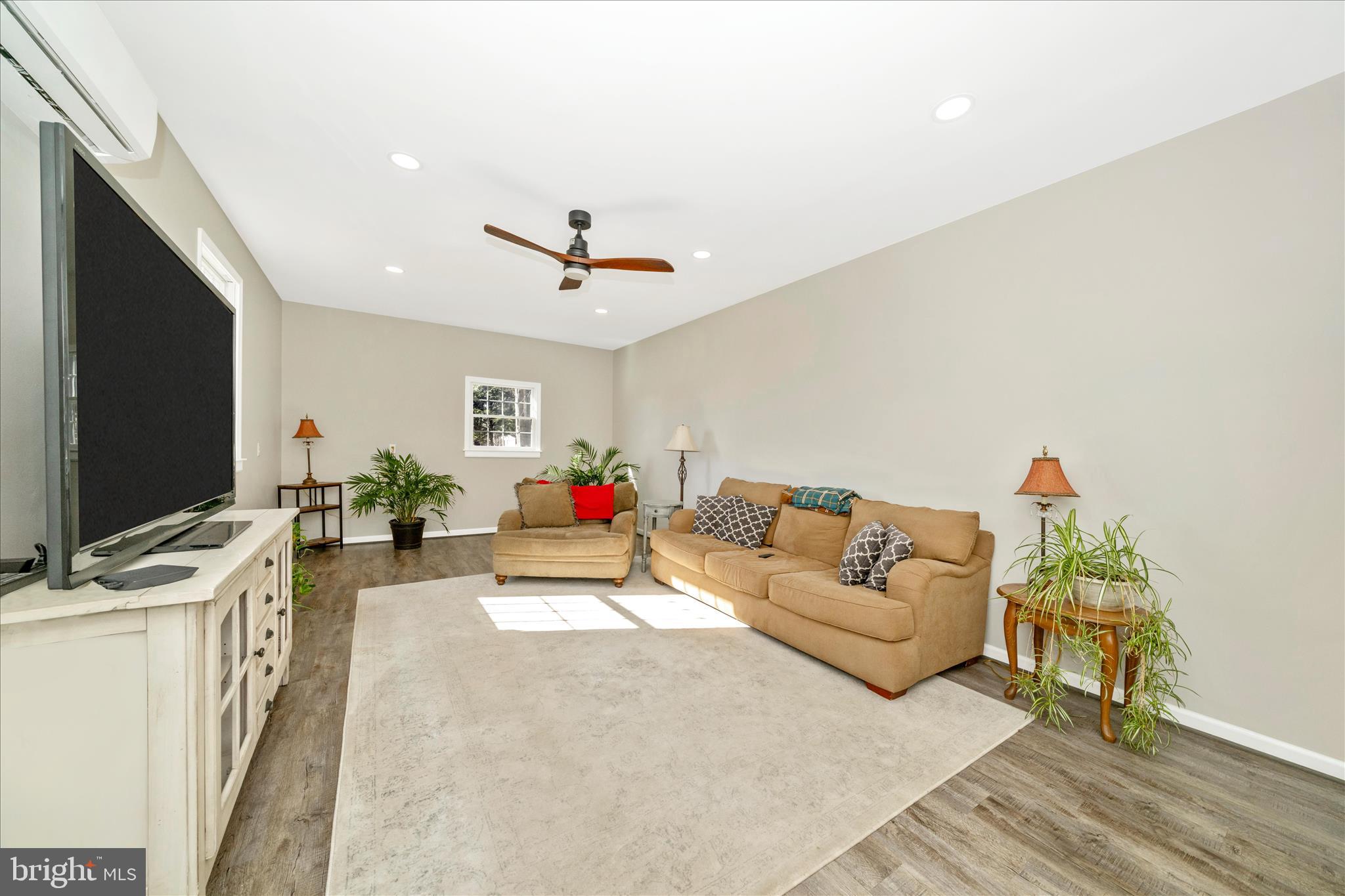 8730 Mapleville Road Mount Airy, MD 21771 - Photo 18 of 65 a living room with furniture and a flat screen tv