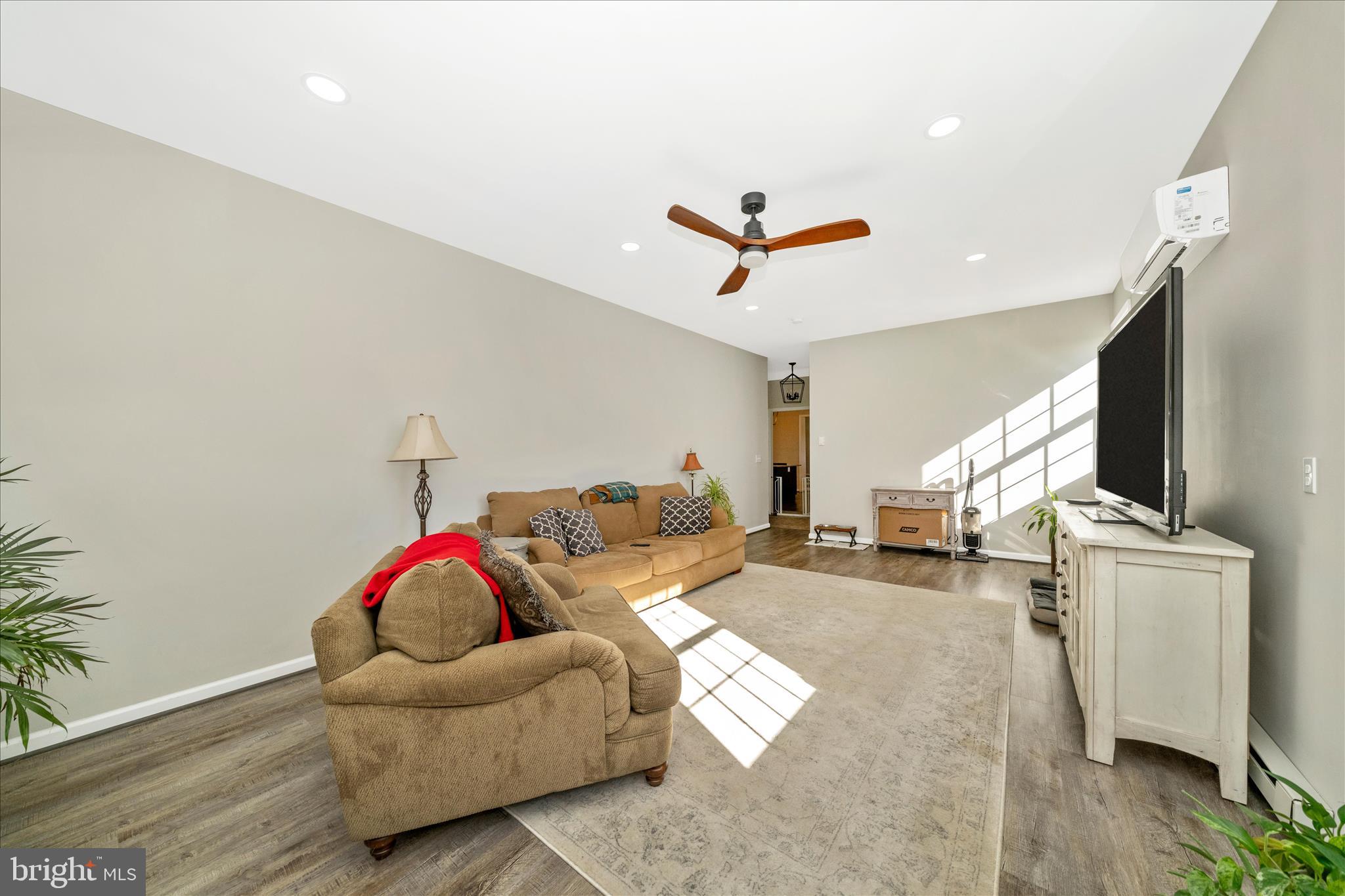 8730 Mapleville Road Mount Airy, MD 21771 - Photo 19 of 65 a living room with furniture and a flat screen tv