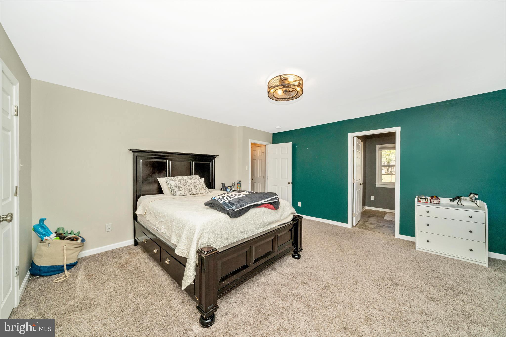 8730 Mapleville Road Mount Airy, MD 21771 - Photo 27 of 65 a spacious bedroom with a bed and a table