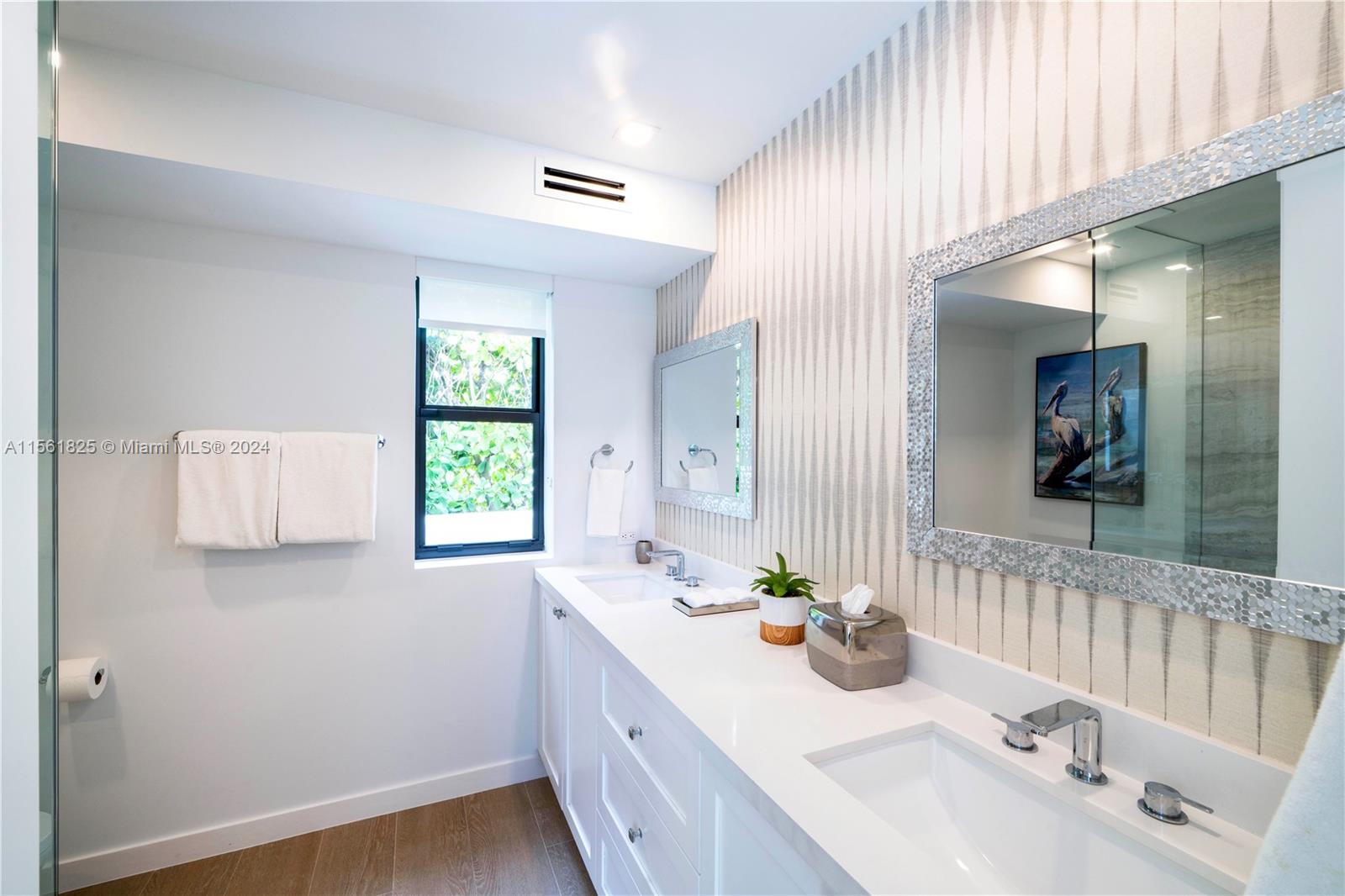 5334 Pine Tree Drive Miami Beach, FL 33140 - Photo 17 of 42 a bathroom with a sink and a mirror