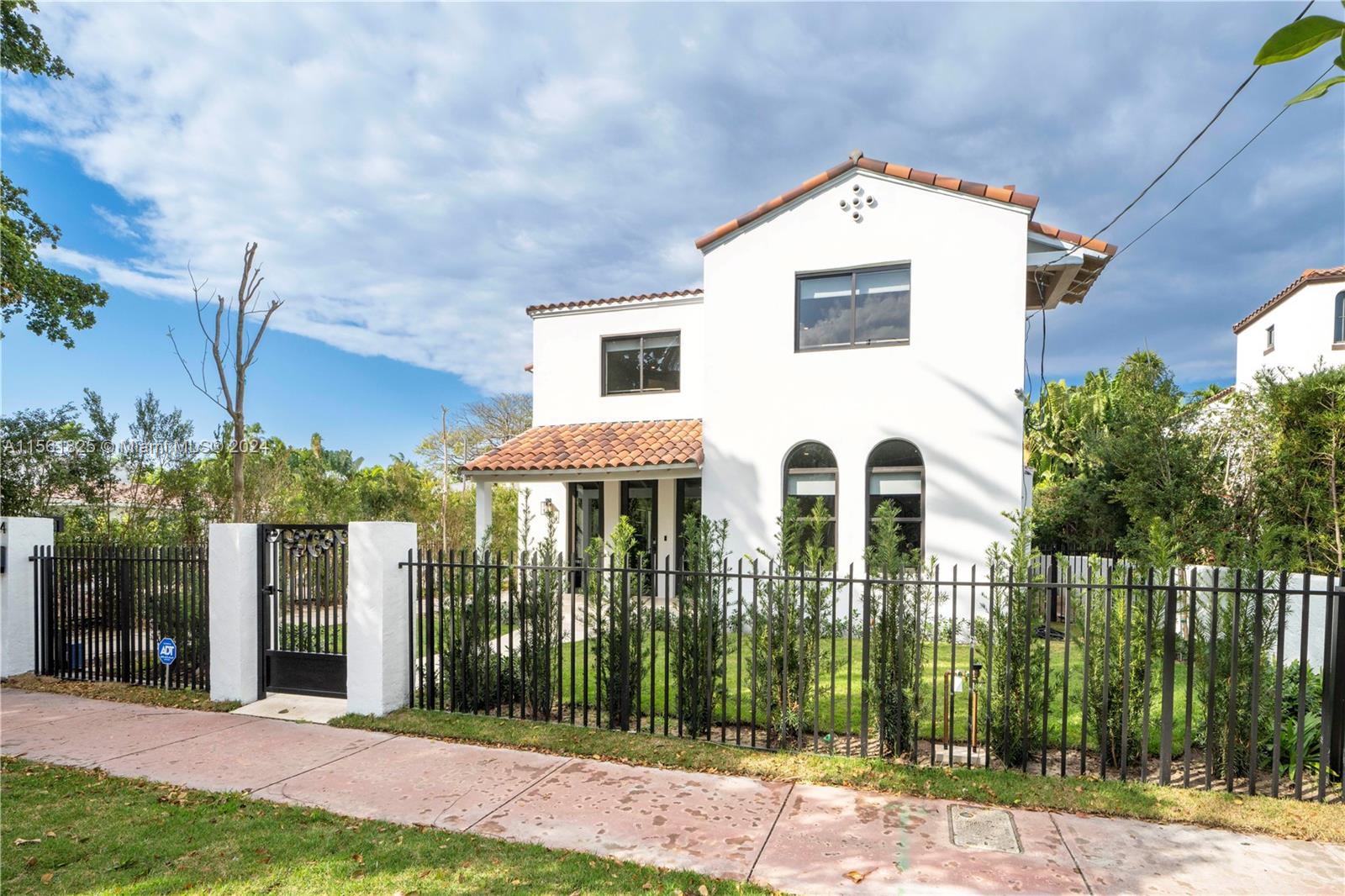 5334 Pine Tree Drive Miami Beach, FL 33140 - Photo 2 of 42 a front view of a house with a yard