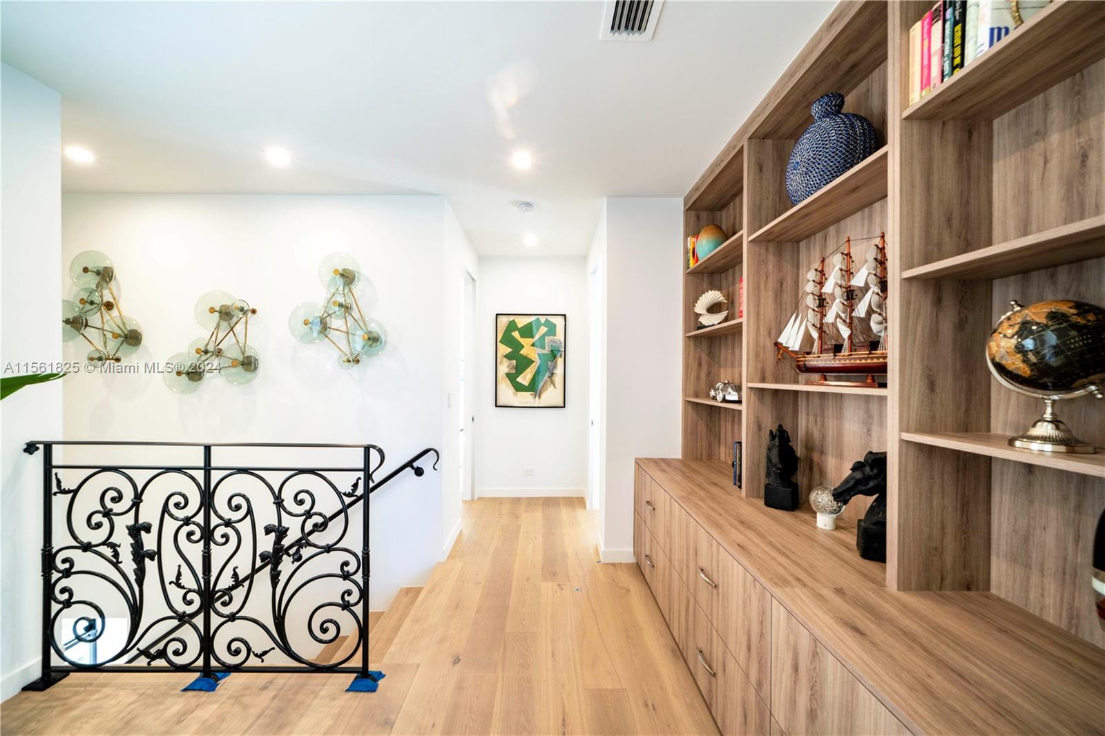 5334 Pine Tree Drive Miami Beach, FL 33140 - Photo 24 of 42 a view of a hallway with wooden floor and cabinets