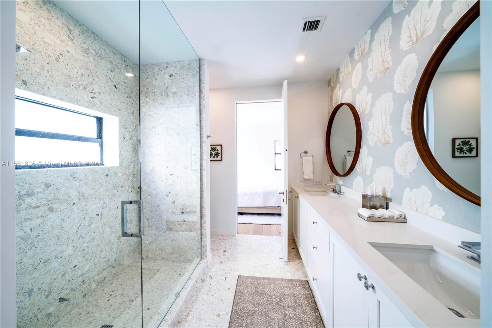 5334 Pine Tree Drive Miami Beach, FL 33140 - Photo 28 of 42 a bathroom with a double vanity sink mirror and shower