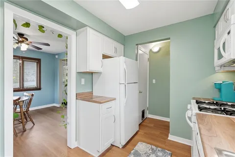 a view of room with window and wooden floor