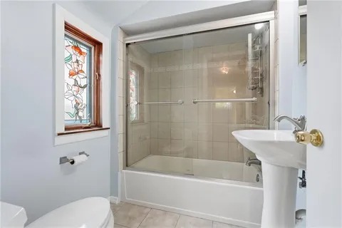 a bathroom with a sink a mirror and a bathtub