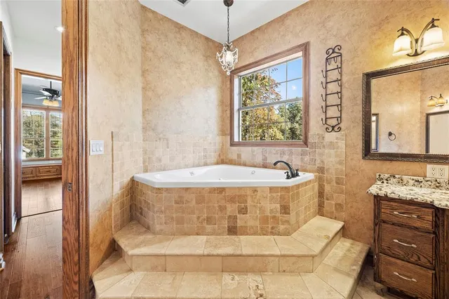 a bath tub sitting in a bathroom next to a window