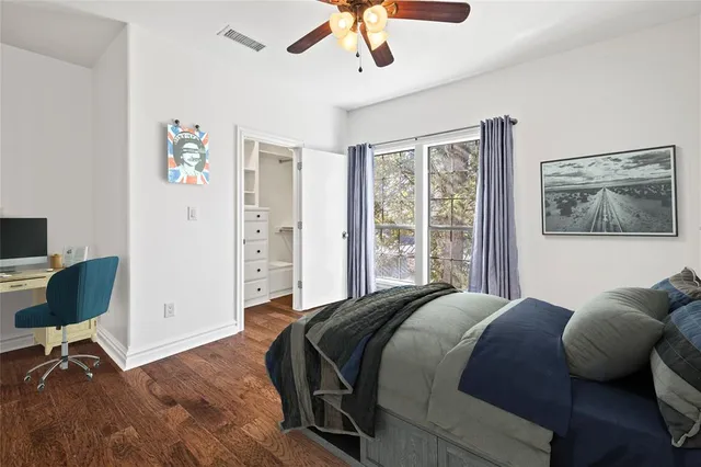 a bedroom with a bed a chair and a chandelier