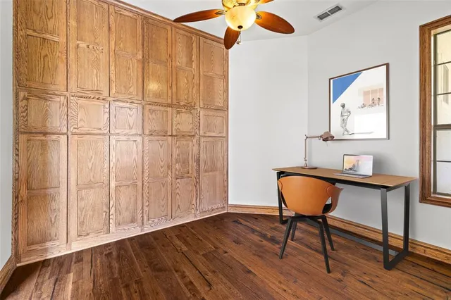 a workspace room with wooden floor table and chair