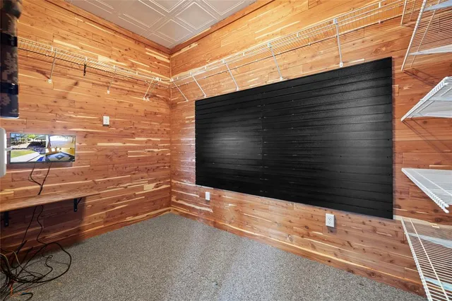 a view of a hallway with wooden floor and windows