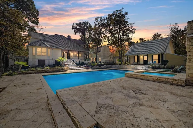 a swimming pool view with a seating space and a garden
