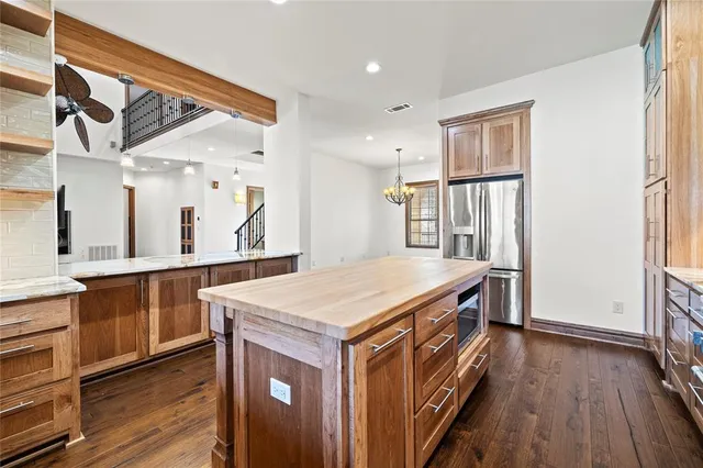 a kitchen with a wooden floor and entrance