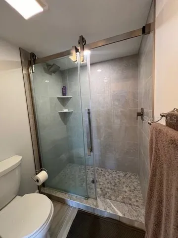 a view of swimming pool with outdoor seating and plants