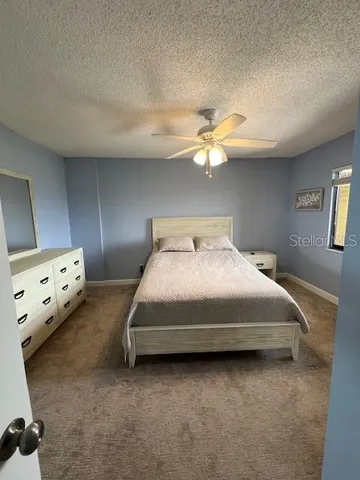 a bedroom with a large bed and a tv