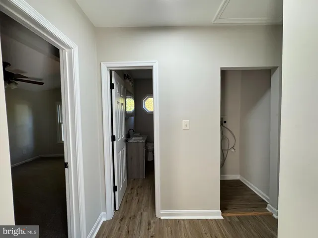 a bathroom with a granite countertop sink and a bathtub