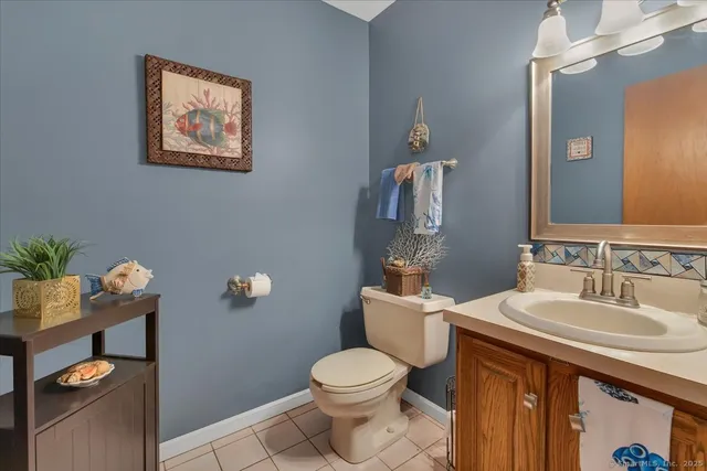 a bathroom with a toilet a sink and mirror