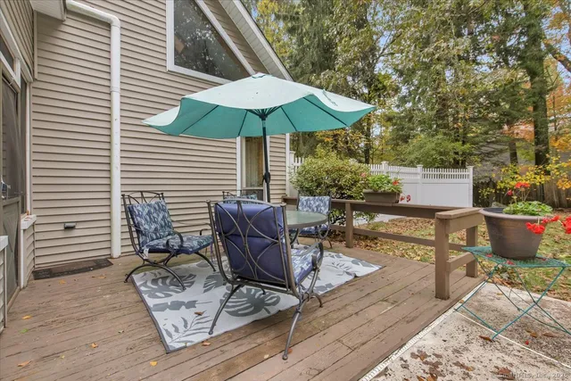 a view of backyard with seating space and wooden floor