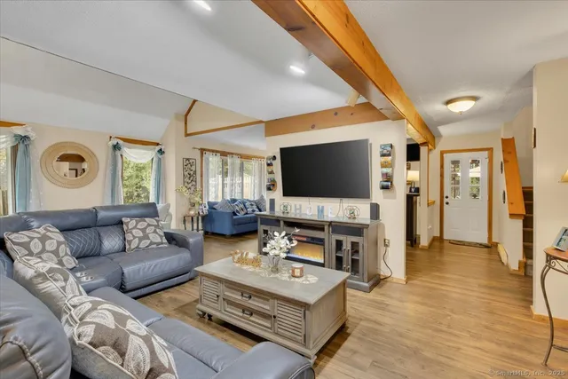 a living room with furniture and a flat screen tv