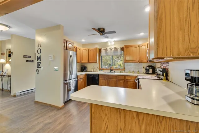 a kitchen with a refrigerator a sink a stove and cabinets