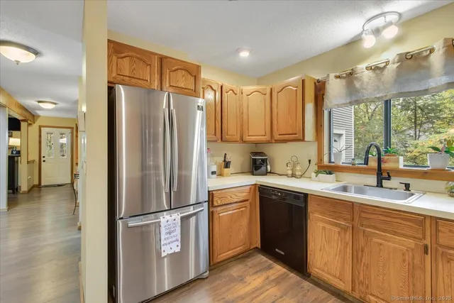 a kitchen with a refrigerator sink and cabinets
