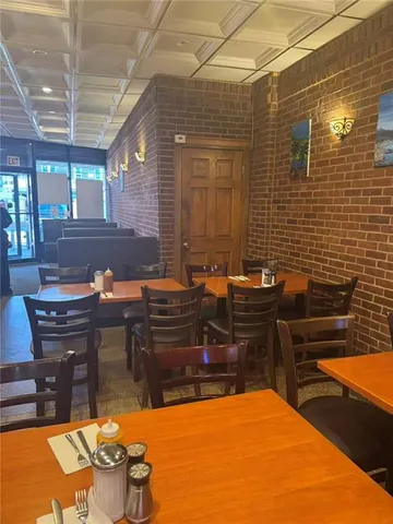 a backyard of a house with table and chairs