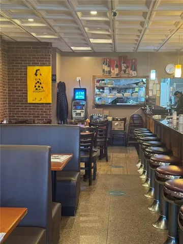 a bathroom with a brick wall and sink