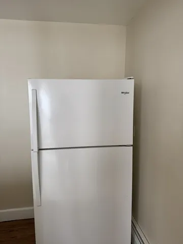 a white refrigerator freezer sitting in a kitchen