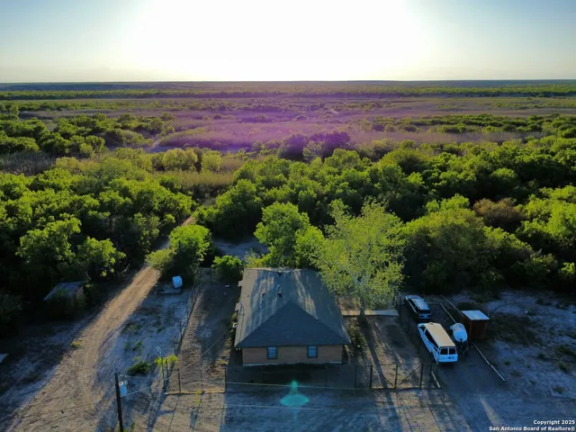 an aerial view of a house with a yard