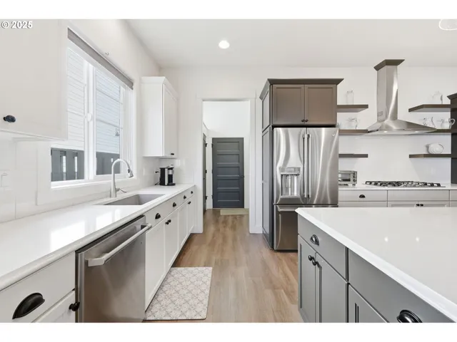 a large white kitchen with a large window