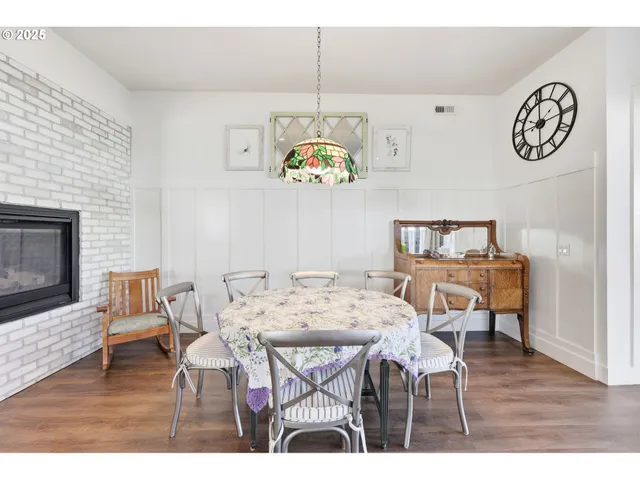 a living room with furniture dining table a table a sink and kitchen view