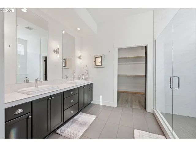 a bathroom with a granite countertop sink two mirror and a