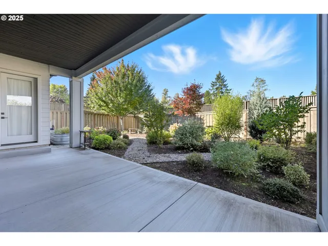a backyard of a house with table and chairs