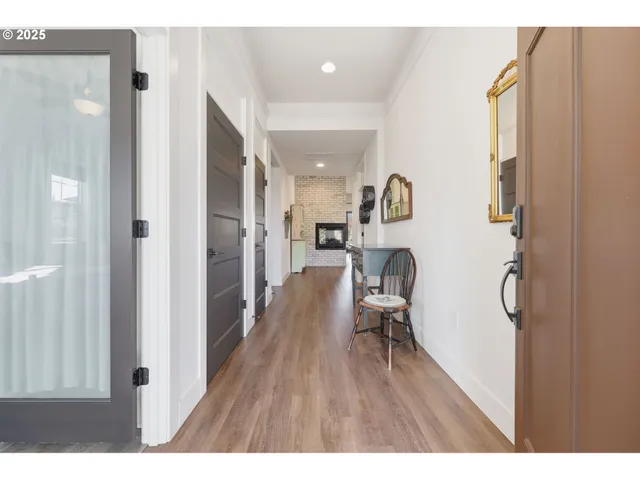 a hallway with wooden floor and furniture