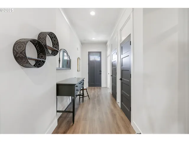 a view of a hallway with wooden floor
