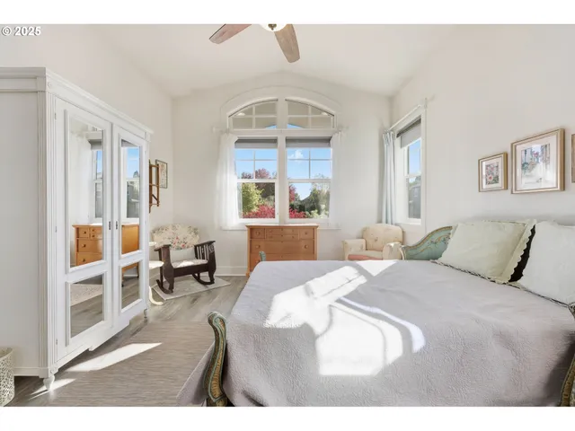 a bedroom with a large bed and a window