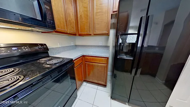 a kitchen with a stove and a refrigerator