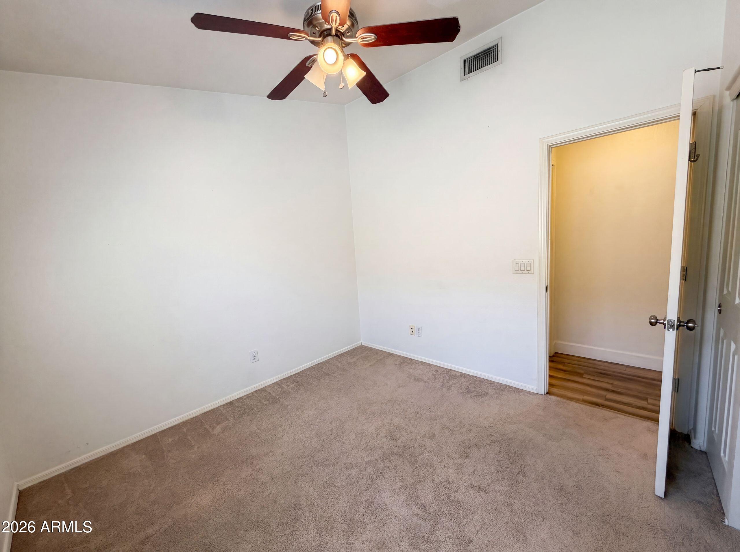 3951 East Timberline Road Gilbert, AZ 85297 - Photo 20 of 28 an empty room with closet and a chandelier fan