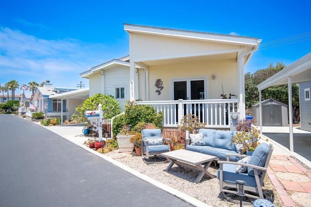 a front view of a house with sitting area