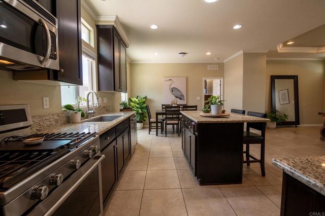 a kitchen with stainless steel appliances granite countertop a stove and a sink