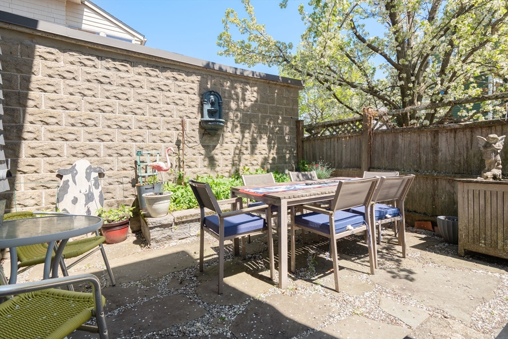 45 Springfield Street, Unit 1 Belmont, MA 02478 - Photo 20 of 27 a view of a patio with table and chairs and potted plants