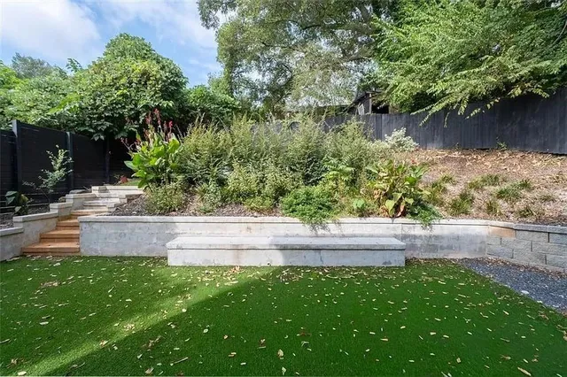 a view of a house with backyard and sitting area